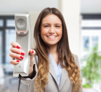 Woman showing the telephone